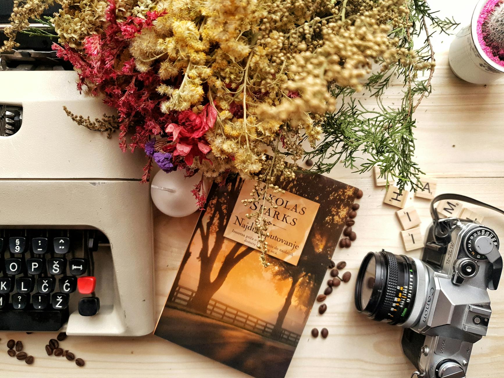 Blumenstrauß Und Buch Auf Holztisch Mit Vintage Schreibmaschine Und Kamera Angeordnet